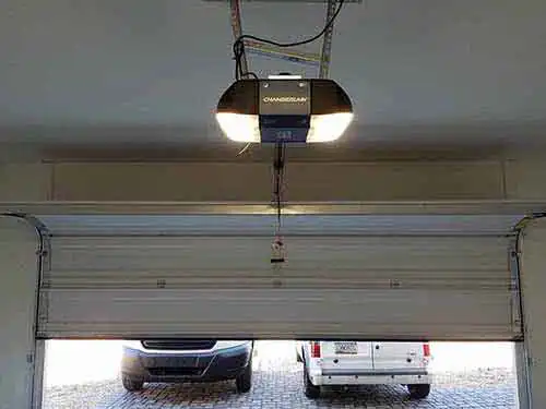 Smart residential garage door opener system installation safari garage door and gate safari garage door and gate Technician installing a residential garage door opener system in Phoenix Arizona