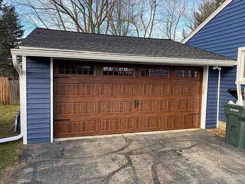 Faux wood carriage house style steel garage door with windows installed on Arizona home in Maricopa County