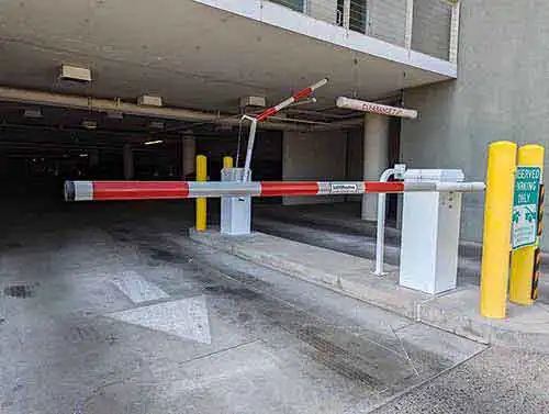 Automatic parking barrier and overhead security gate system safari garage door and gate safari garage door and gate Automatic parking barrier gate and overhead security gate system installed at a commercial property in Phoenix Arizona