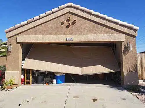Residential garage door repair and maintenance experts in arizona safari garage door and gate safari garage door and gate Technician performing residential garage door repair and maintenance service in Phoenix Arizona