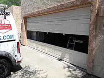 Garage door panel replacement service in maricopa county safari garage door and gate safari garage door and gate Technician replacing damaged garage door panel on residential home in Maricopa County Arizona