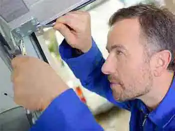 Garage door tune up and maintenance in maricopa county safari garage door and gate safari garage door and gate Technician performing garage door tune up and maintenance service on residential door in Phoenix Arizona