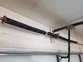 Garage door spring replacement service in maricopa county safari garage door and gate safari garage door and gate Technician replacing broken torsion spring on residential garage door in Phoenix Arizona